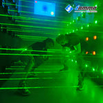 MetaNexusXR's vibrant green laser maze kit slices through smoke in an immersive game room. | MetaNexusXR
